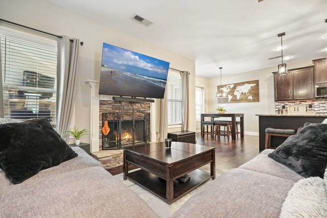 48 Ironwood Ct, Dallas, GA 30132 - living room featuring visible vents, a fireplace, baseboards, and wood finished floors