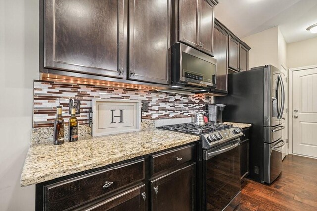 48 Ironwood Ct, Dallas, GA 30132 - kitchen with appliances with stainless steel finishes, dark wood-style flooring, backsplash, and dark brown cabinets