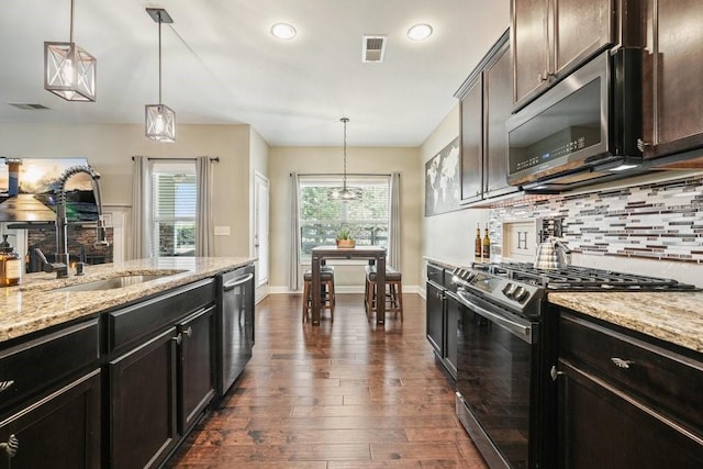 48 Ironwood Ct, Dallas, GA 30132 - kitchen featuring dark wood-style flooring, stainless steel appliances, tasteful backsplash, visible vents, and a sink