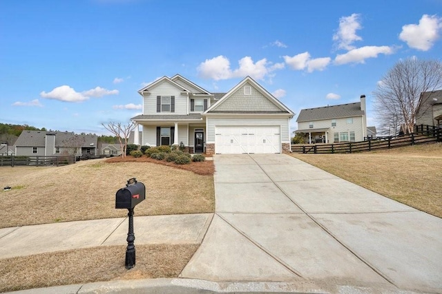 48 Ironwood Ct, Dallas, GA 30132 - craftsman-style home featuring an attached garage, a front yard, fence, stone siding, and driveway