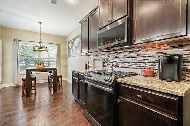 48 Ironwood Ct, Dallas, GA 30132 - kitchen featuring dark brown cabinetry, stainless steel appliances, backsplash, light stone countertops, and dark wood-style floors