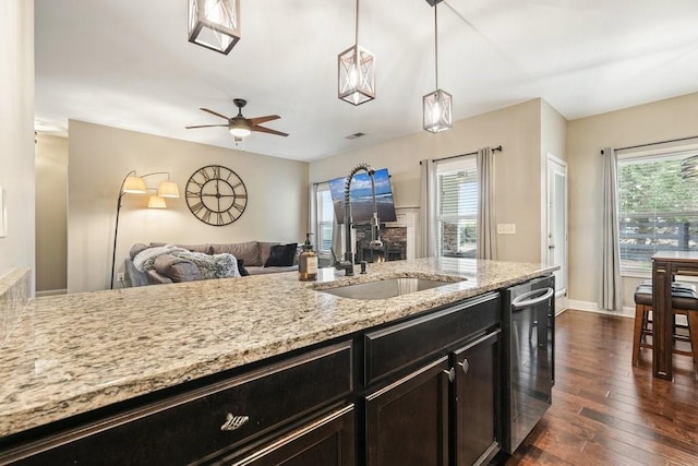48 Ironwood Ct, Dallas, GA 30132 - kitchen featuring dishwasher, light stone counters, open floor plan, dark wood-style flooring, and a sink