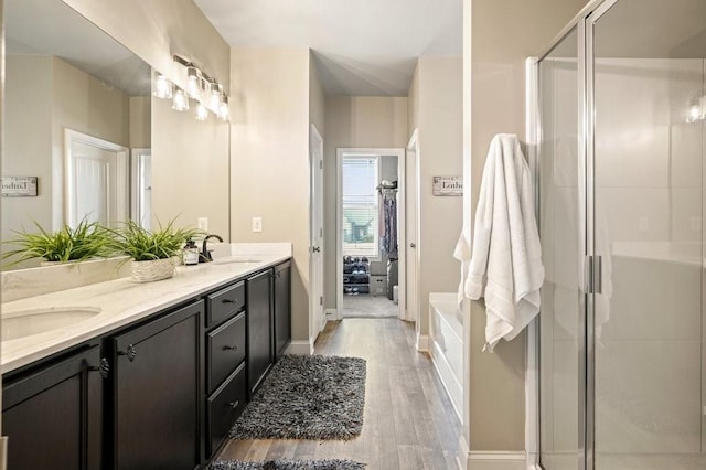 48 Ironwood Ct, Dallas, GA 30132 - full bathroom featuring double vanity, a shower stall, a sink, and wood finished floors