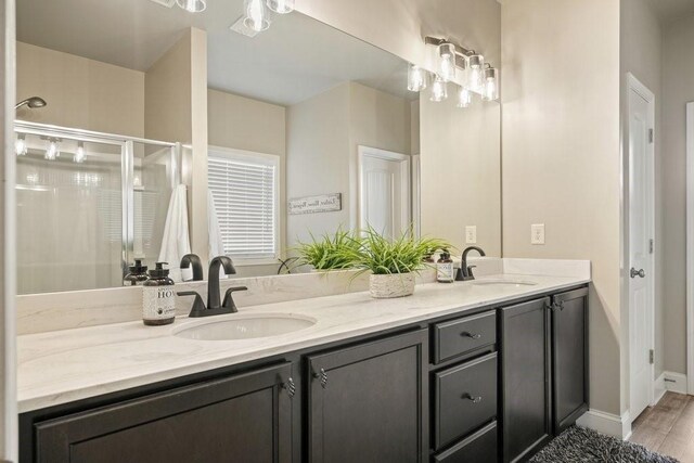 48 Ironwood Ct, Dallas, GA 30132 - bathroom featuring double vanity, a stall shower, a sink, and baseboards