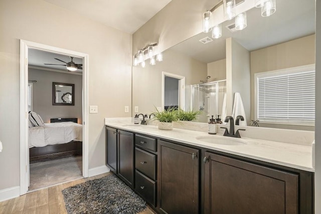 48 Ironwood Ct, Dallas, GA 30132 - ensuite bathroom with double vanity, a shower stall, a sink, and wood finished floors