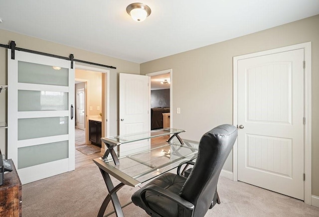 48 Ironwood Ct, Dallas, GA 30132 - home office with light carpet, baseboards, and a barn door