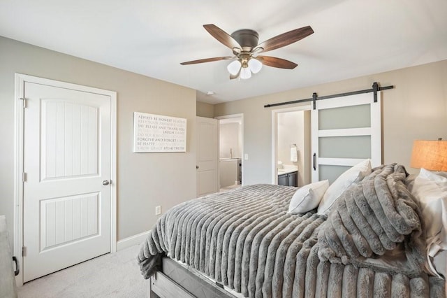 48 Ironwood Ct, Dallas, GA 30132 - carpeted bedroom featuring a barn door, baseboards, ceiling fan, and ensuite bathroom