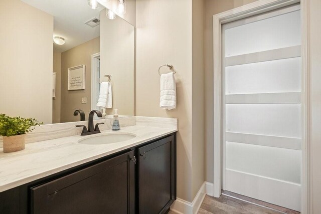 48 Ironwood Ct, Dallas, GA 30132 - bathroom with visible vents, vanity, baseboards, and wood finished floors
