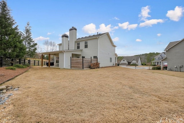 48 Ironwood Ct, Dallas, GA 30132 - rear view of house with a chimney and fence