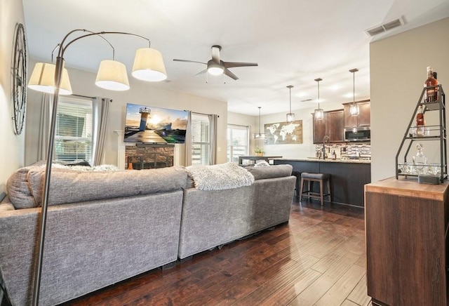 48 Ironwood Ct, Dallas, GA 30132 - living area featuring ceiling fan, a fireplace, visible vents, and dark wood-type flooring