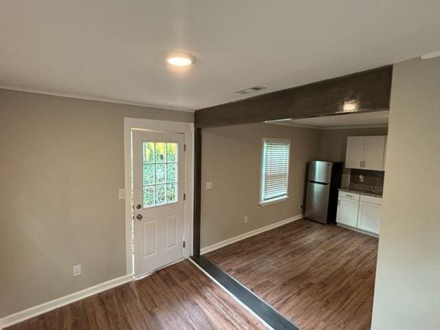 entryway with dark hardwood / wood-style flooring and a wealth of natural light