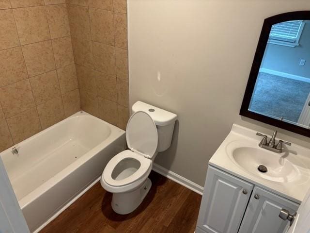 bathroom featuring wood-type flooring, toilet, and vanity