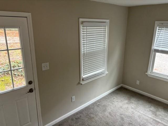 doorway with carpet floors and plenty of natural light