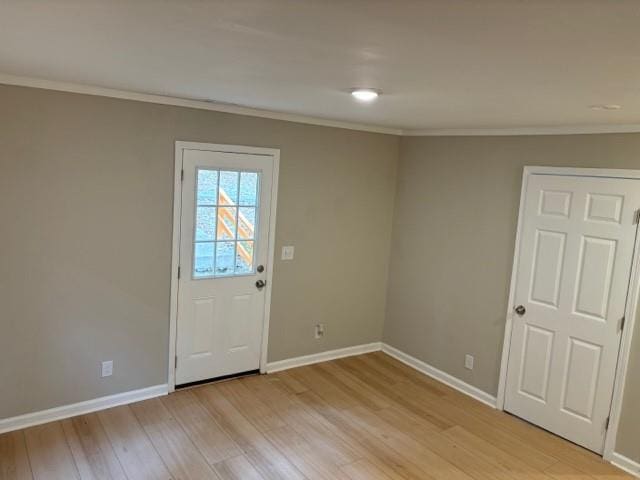 interior space with crown molding and light wood-type flooring