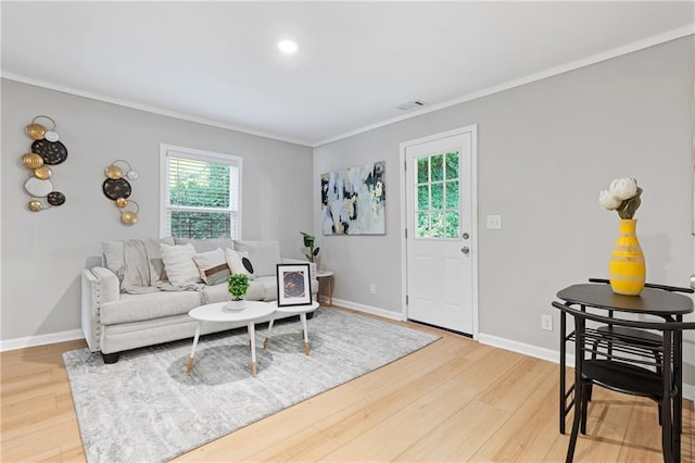 living room featuring hardwood / wood-style flooring and ornamental molding