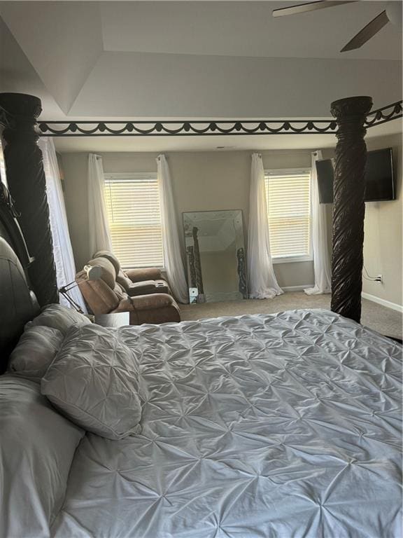 bedroom with ceiling fan, multiple windows, baseboards, and carpet flooring