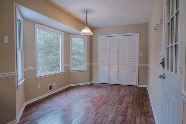110 Fox Meadow Dr, Covington, GA 30016 - unfurnished dining area with wood finished floors, plenty of natural light, baseboards, and a textured ceiling