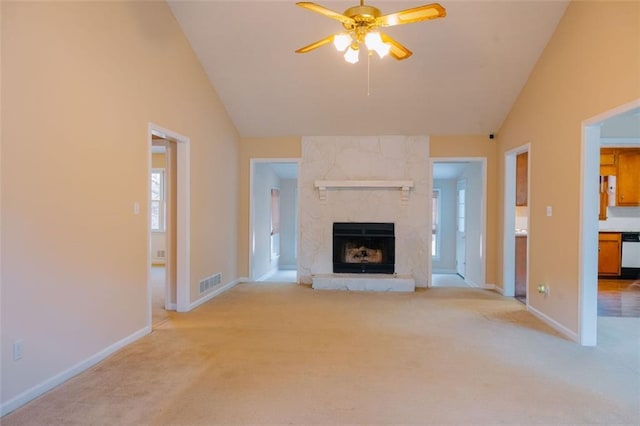 110 Fox Meadow Dr, Covington, GA 30016 - unfurnished living room with ceiling fan, lofted ceiling, light colored carpet, a large fireplace, and baseboards