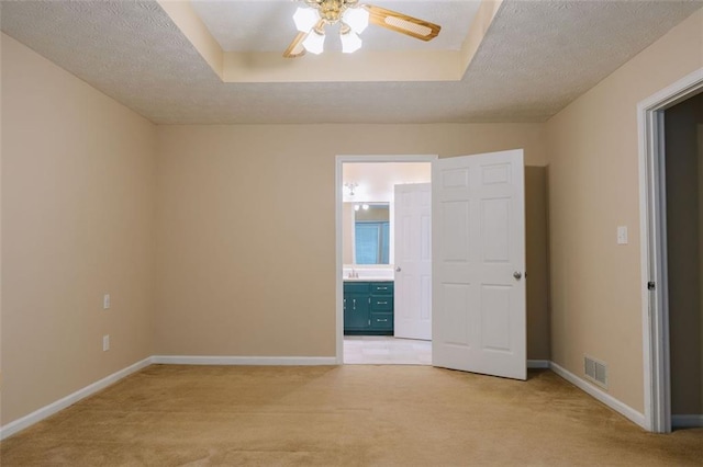 110 Fox Meadow Dr, Covington, GA 30016 - unfurnished bedroom featuring light colored carpet, baseboards, a textured ceiling, ensuite bathroom, and a ceiling fan