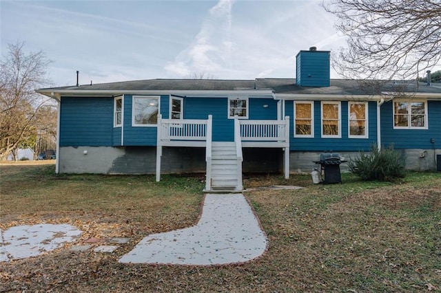 110 Fox Meadow Dr, Covington, GA 30016 - back of house with a chimney, a deck, a lawn, and stairway