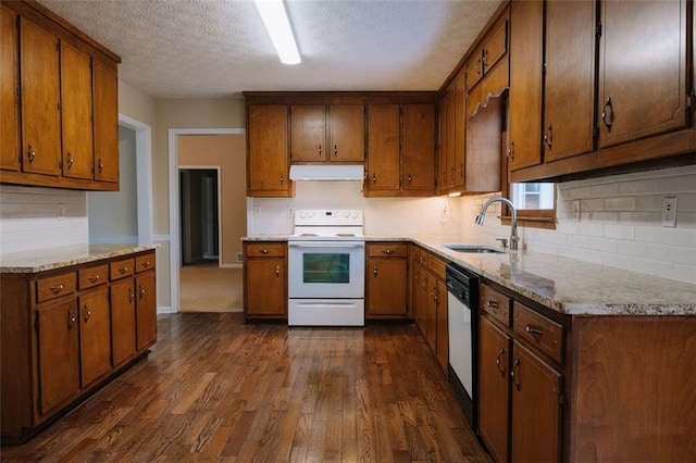 110 Fox Meadow Dr, Covington, GA 30016 - kitchen featuring electric range, a sink, under cabinet range hood, dishwasher, and dark wood-type flooring