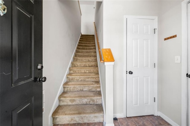stairs featuring baseboards