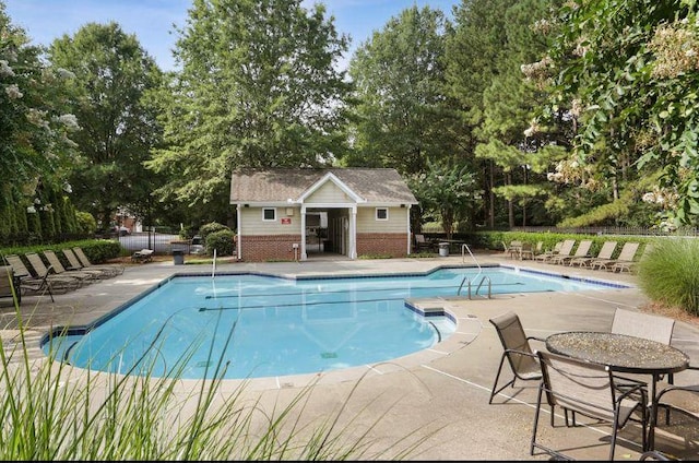 townhome / multi-family property with an attached garage, driveway, and brick siding
