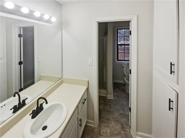 bathroom featuring vanity and toilet