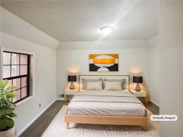 carpeted bedroom featuring vaulted ceiling