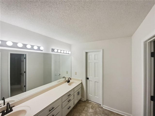 bathroom with vanity and a textured ceiling