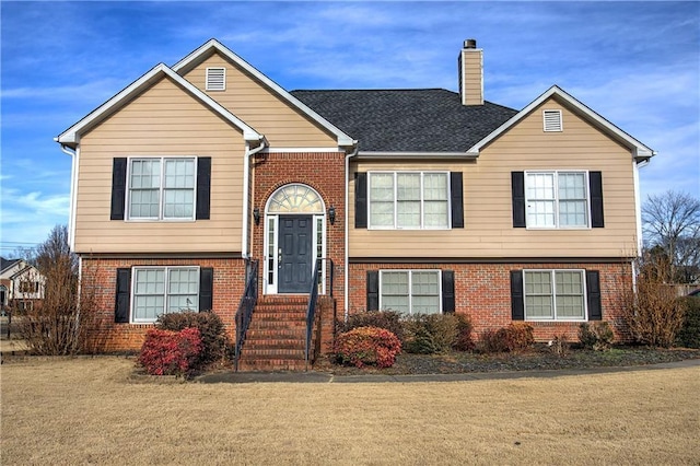 raised ranch with a front yard