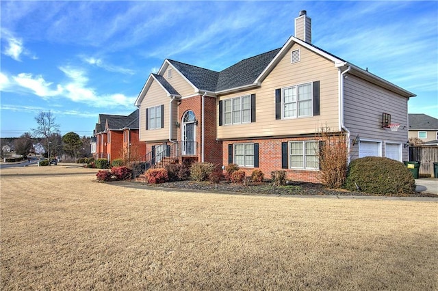 view of front of house featuring a garage and a front lawn