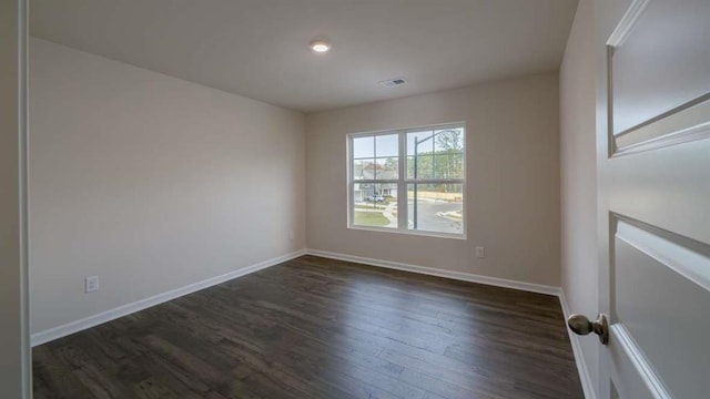 unfurnished room featuring dark hardwood / wood-style flooring