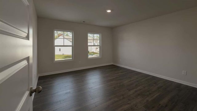 unfurnished room featuring dark wood-type flooring