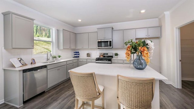 kitchen with dark hardwood / wood-style flooring, decorative backsplash, gray cabinets, and stainless steel appliances