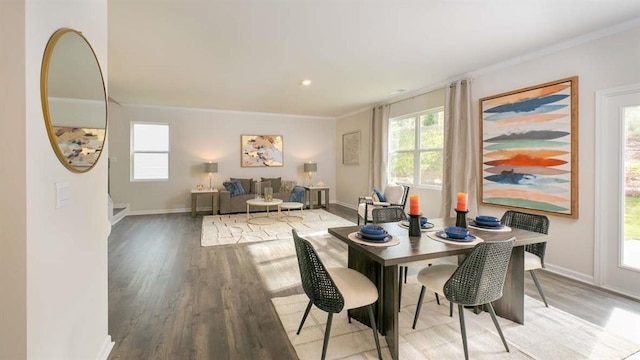 dining space with crown molding and wood-type flooring