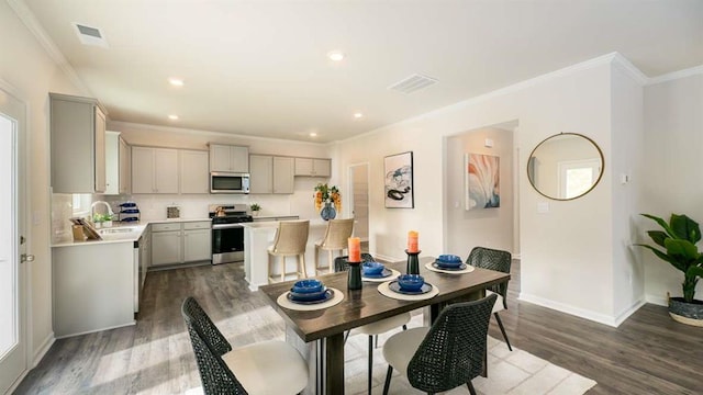 dining space with dark hardwood / wood-style flooring and ornamental molding