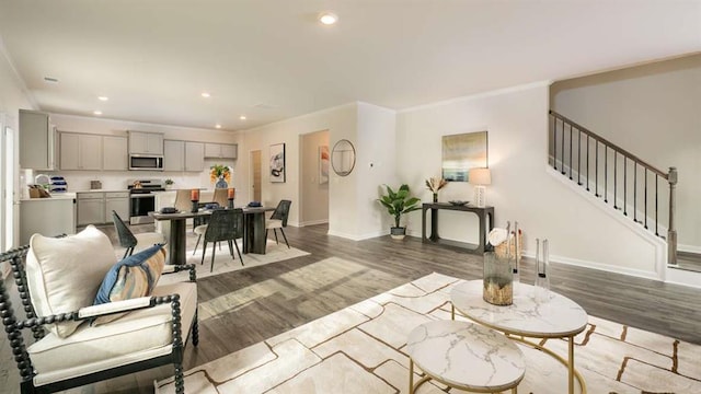 living room with hardwood / wood-style floors and ornamental molding