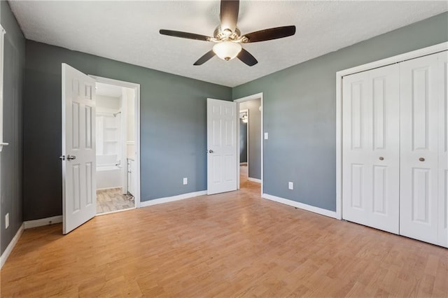 unfurnished bedroom featuring light wood finished floors, a closet, a ceiling fan, and baseboards