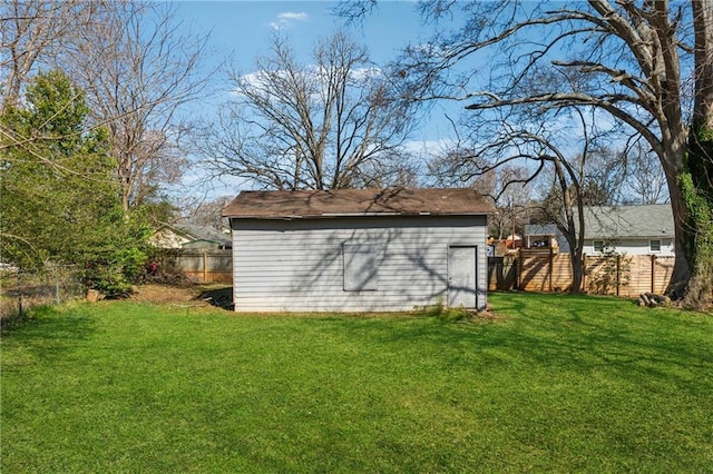 view of yard featuring an outbuilding, a storage unit, and a fenced backyard