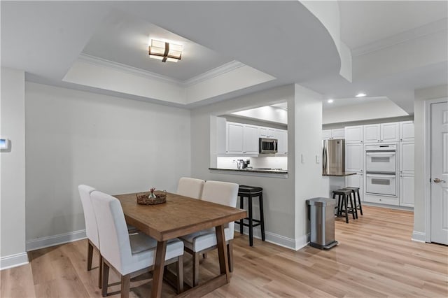 3636 Habersham Rd NW Unit 2101, Atlanta, GA 30305 - dining space featuring a tray ceiling, ornamental molding, light wood-type flooring, and recessed lighting