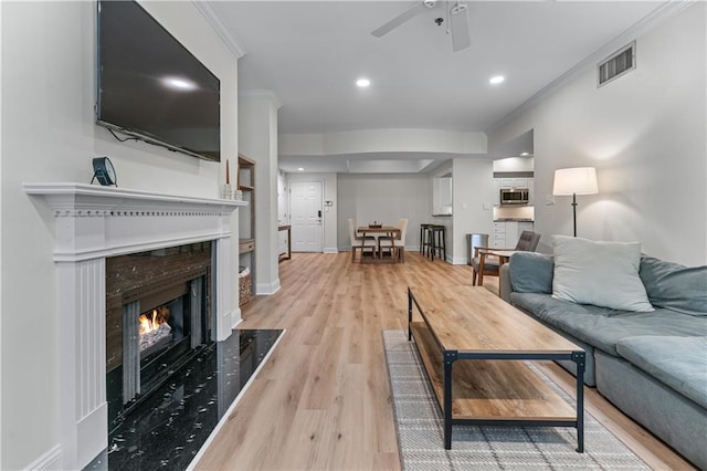 3636 Habersham Rd NW Unit 2101, Atlanta, GA 30305 - living room featuring a premium fireplace, ceiling fan, crown molding, light wood-style flooring, and recessed lighting