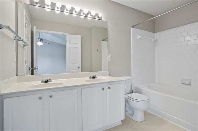 full bathroom featuring tiled shower / bath, ceiling fan, toilet, vanity, and tile patterned floors