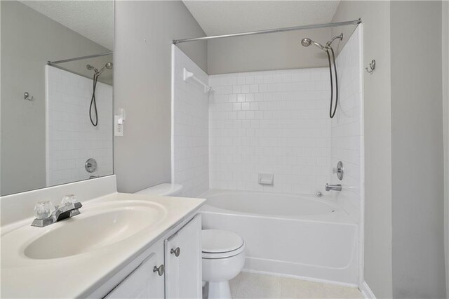 full bathroom with toilet, tile patterned flooring, tiled shower / bath, vanity, and a textured ceiling