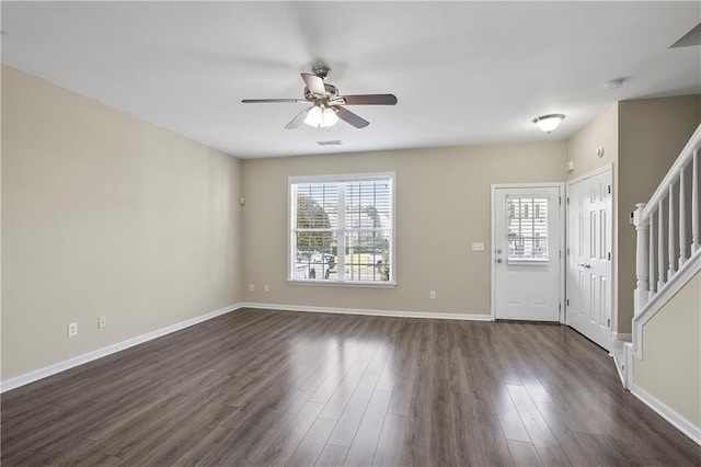 foyer entrance with ceiling fan and dark hardwood / wood-style flooring