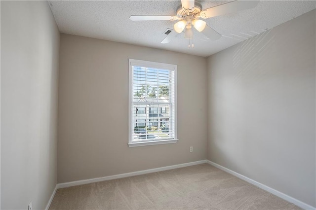 unfurnished room with a textured ceiling, light colored carpet, and ceiling fan