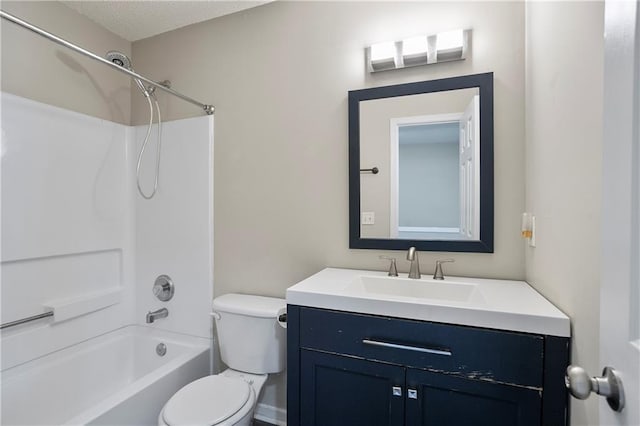 full bathroom featuring toilet, shower / washtub combination, a textured ceiling, and vanity