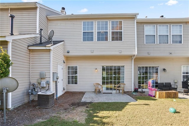 back of house with a patio, cooling unit, and a yard