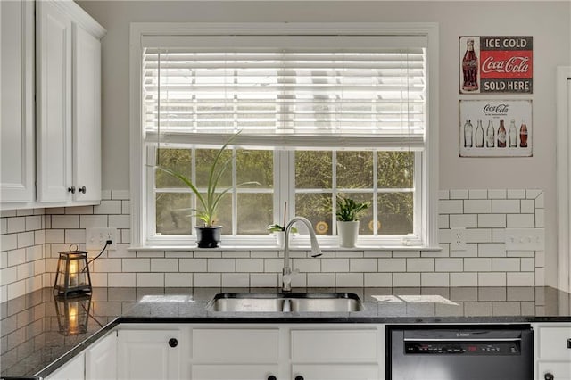 kitchen with a sink, white cabinetry, dishwasher, and a healthy amount of sunlight