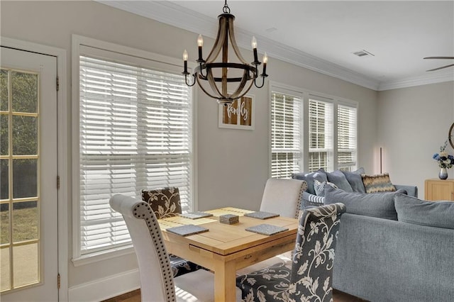 dining space with a chandelier, visible vents, baseboards, and ornamental molding